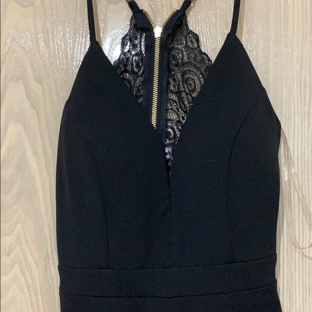 Never worn open back black romper
